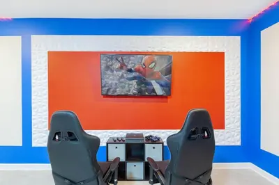 a room with two chairs and a painting on the wall at Gorgeous 6BR at Storey Lake next to Disney - 2850 in Kissimmee