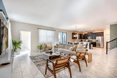 a living room with a couch and a table at Stunning 6BR Lakeview at Storey Lake next to Disney - 2929 in Kissimmee