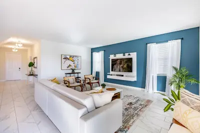 a living room with a white couch and blue walls at Stunning 6BR Lakeview at Storey Lake next to Disney - 2929 in Kissimmee