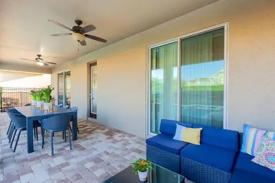 a living room with a blue couch and a table at Gorgeous 8BR PetFriendly at Encore Resort next to Disney - 7625 in Orlando