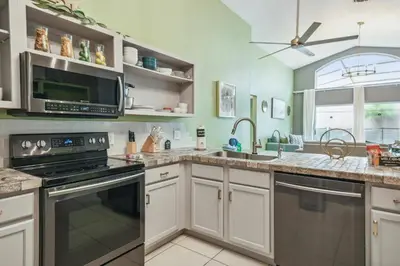 a kitchen with a sink and a stove top oven at Lake Berkley 5Q, Piscina Aquecida, Perto Disney in Kissimmee