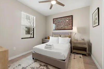 a bedroom with a bed and a ceiling fan at The Hub Beautiful Townhome Near Parks in Kissimmee