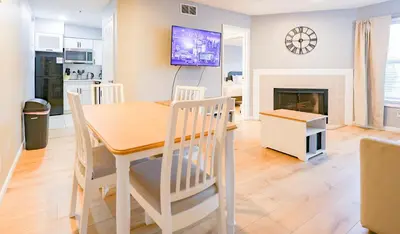a kitchen and dining room with a table and chairs at Disney Universal Family Resort # Pool # Gym in Orlando