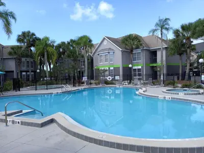 a large swimming pool in front of condos at Disney Universal Family Resort # Pool # Gym in Orlando