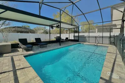 a swimming pool in a house with a glass roof at Charming 4 Bdr Villa near Disney in Kissimmee
