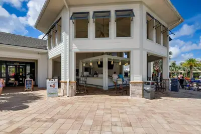 a large white building with tables and chairs at C4731-203-Storey Lake Resort Near Disney-Universal in Kissimmee