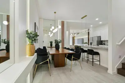 a kitchen and dining room with a table and chairs at Orlando Paradise 5BR Themed Home in Orlando