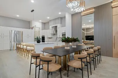 a kitchen and dining room with a table and chairs at Themed 15BR Mansion - Near Parks in Kissimmee