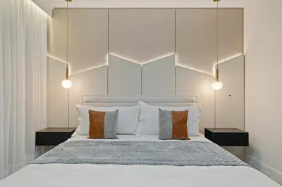a bedroom with a large white bed with pillows at Themed 15BR Mansion - Near Parks in Kissimmee