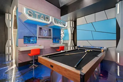 a play room with a pool table and star wars sign at Themed 15BR Mansion - Near Parks in Kissimmee