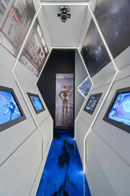 a room with a star wars exhibit with three monitors at Themed 15BR Mansion - Near Parks in Kissimmee