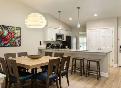 a kitchen and dining room with a table and chairs at Weekly rental at Orange Lake Resort for a family of 8 people in Orlando