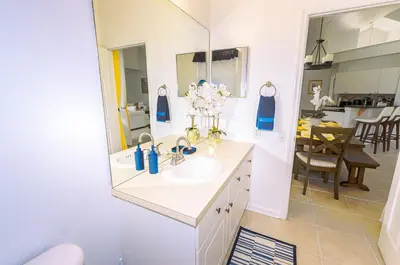 a bathroom with a sink and a mirror at Spacious Home Perfect for Big Families in Kissimmee