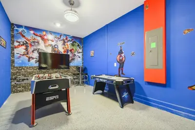 a room with a superhero themed room with a ping pong table at Storey Lake * Linda Casa 5 quartos com sala de jogos in Kissimmee