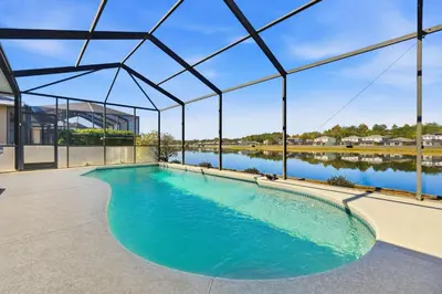 a large swimming pool in a large building with a large swimming pool at 2989 - Flamingo Farmhouse in Kissimmee