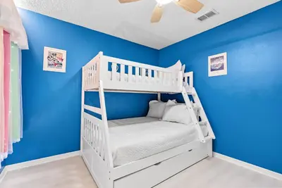 a white bunk bed in a room with blue walls at Comfortable 6-Bedroom Getaway Near Top Attractions in Kissimmee