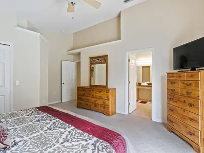 a bedroom with a bed and a flat screen tv at Holiday Home Ferienvilla mit Garten- Grill und Terrasse by Interhome in Orlando