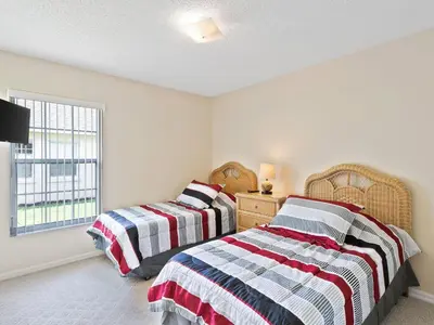 a bedroom with two beds and a window at Holiday Home Ferienvilla mit Garten- Grill und Terrasse by Interhome in Orlando