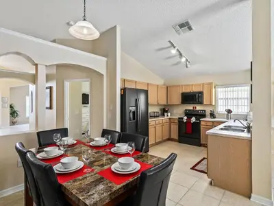 a kitchen and dining room with a table and chairs at Holiday Home Ferienvilla mit Garten- Grill und Terrasse by Interhome in Orlando