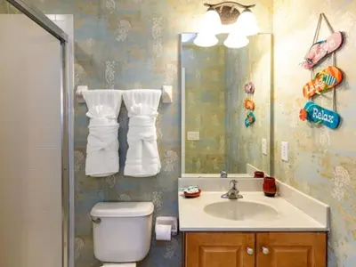 a bathroom with a sink and a toilet and a mirror at Holiday Home Bella Vida Resort Pool und Spa Rückzugsort by Interhome in Kissimmee
