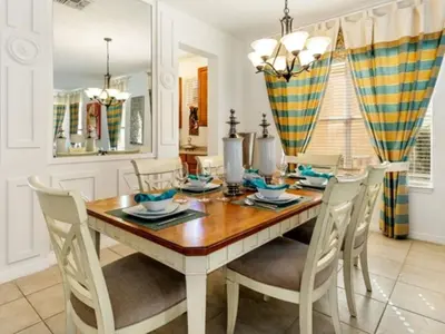 a dining room with a wooden table and chairs at Holiday Home Bella Vida Resort Pool und Spa Rückzugsort by Interhome in Kissimmee
