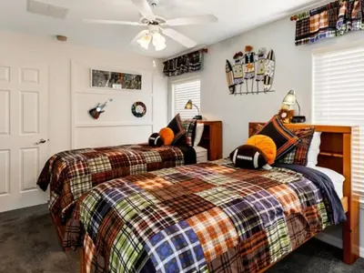 two twin beds in a room with a ceiling fan at Holiday Home Bella Vida Resort Pool und Spa Rückzugsort by Interhome in Kissimmee