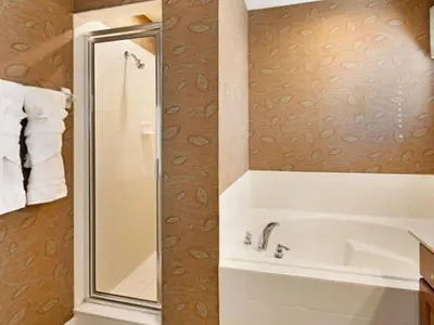a bathroom with a shower and a white tub at Holiday Home Bella Vida Resort Pool und Spa Rückzugsort by Interhome in Kissimmee