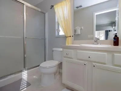 a bathroom with a toilet and a sink and a shower at Holiday Home 4-Schlafzimmer-Ferienhaus mit Whirlpool by Interhome in Kissimmee
