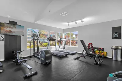 a gym with several exercise equipment in a room at Resort Stay Near Disney Bright Gym Hot Tub in Kissimmee