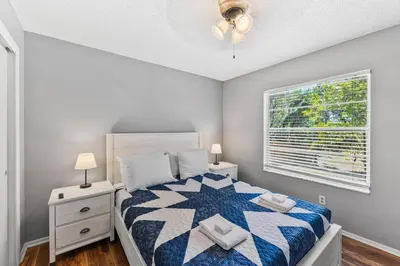 a bedroom with a large bed and a window at 7694 Indian Ridge Trail S in Orlando