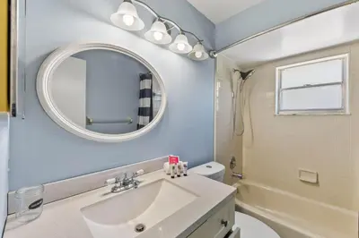 a bathroom with a sink and a mirror at 7694 Indian Ridge Trail S in Orlando