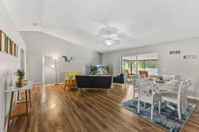 a living room and dining room with a table and chairs at 7694 Indian Ridge Trail S in Orlando