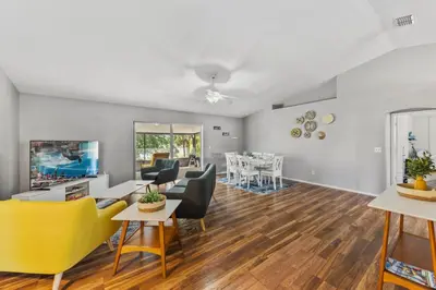 a living room with a couch and chairs and a tv at 7694 Indian Ridge Trail S in Orlando