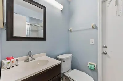 a bathroom with a sink and a toilet and a mirror at 7694 Indian Ridge Trail S in Orlando