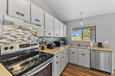 a kitchen with white cabinets and a stove top oven at 7694 Indian Ridge Trail S in Orlando