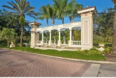 a white gazebo in a park with palm trees at 648 - Spacious 6-Bedroom Emerald Island Retreat with Pool, Spa & Games Room Near Disney in Kissimmee