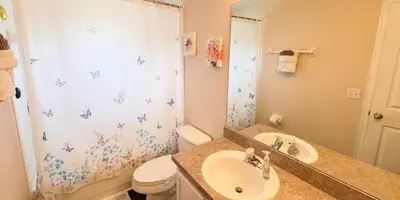 a bathroom with a sink and a toilet and a shower at 648 - Spacious 6-Bedroom Emerald Island Retreat with Pool, Spa & Games Room Near Disney in Kissimmee