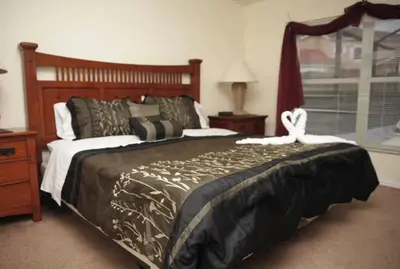 a bedroom with a large bed and a window at Lake Berkley 5 bedroom 3 bath villa near Disneyland in Kissimmee