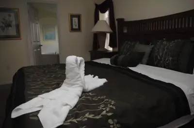 a hotel room with two beds with white towels on the bed at Lake Berkley 5 bedroom 3 bath villa near Disneyland in Kissimmee