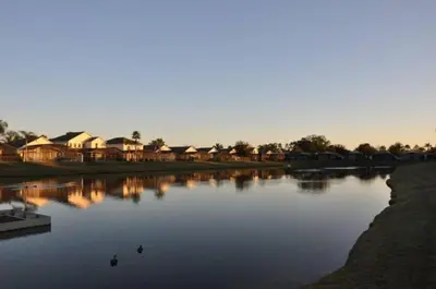 a river with houses and ducks in the water at Lake Berkley 5 bedroom 3 bath villa near Disneyland in Kissimmee