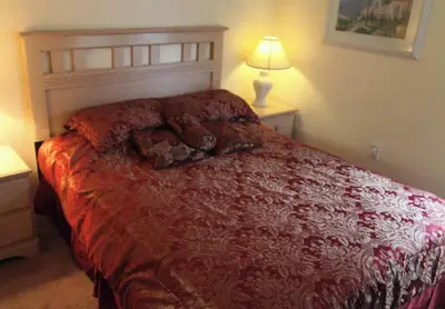 a bedroom with a red bed with a teddy bear on it at Lake Berkley 5 bedroom 3 bath villa near Disneyland in Kissimmee