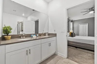 a bathroom with a sink and a large mirror at 4177 Paragraph Drive in Kissimmee