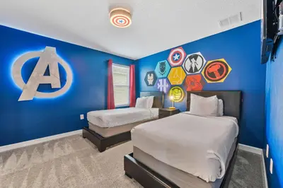 two beds in a room with a blue wall at 4177 Paragraph Drive in Kissimmee