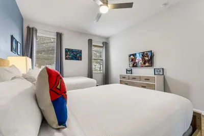 a bedroom with two white beds and two windows at 4449 Shiva Loop in Kissimmee