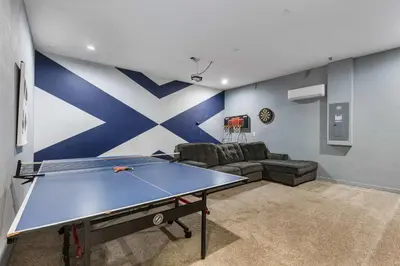 a living room with a ping pong table in it at 4449 Shiva Loop in Kissimmee
