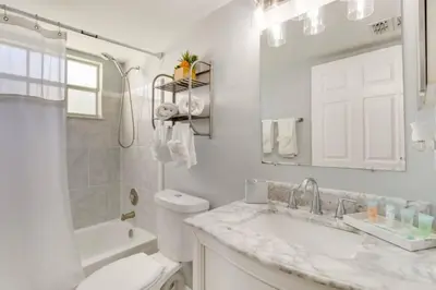 a white bathroom with a toilet and a sink at Villa at Laguna Bay in Kissimmee
