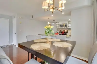 a dining room table with a vase of flowers on it at Villa at Laguna Bay in Kissimmee