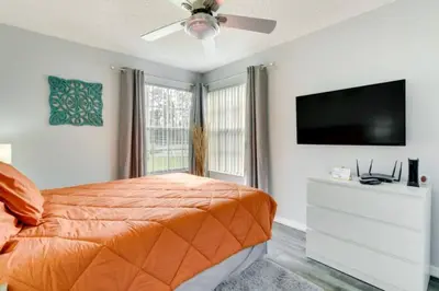 a bedroom with a bed and a flat screen tv at Villa at Laguna Bay in Kissimmee