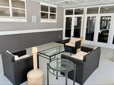 a room with two chairs and a glass table at Condo Universal Disney Epic Free Parking in Orlando