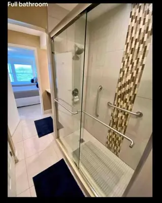 a shower with a glass door in a bathroom at Condo Free Parking near Disney Universal in Orlando
